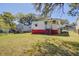 Spacious backyard featuring a large grassy area and mature trees surrounding the property at 2641 Woodlawn Ave, North Charleston, SC 29405