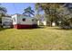 Large, grassy fenced backyard with stairs leading to the back of the home at 2641 Woodlawn Ave, North Charleston, SC 29405