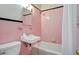 Cozy pink tiled bathroom features a toilet, sink, tub and shower at 2641 Woodlawn Ave, North Charleston, SC 29405