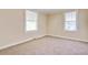 Bright bedroom with neutral walls, carpeting, and windows allowing ample natural light at 2641 Woodlawn Ave, North Charleston, SC 29405