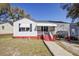 Charming one-story home featuring a red-painted foundation and stair risers, offering curb appeal at 2641 Woodlawn Ave, North Charleston, SC 29405