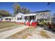 Quaint one-story house with a covered carport and a red-painted base, providing convenience and style at 2641 Woodlawn Ave, North Charleston, SC 29405