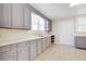 Updated kitchen featuring painted cabinets, wood-look floors, and ample counter space at 2641 Woodlawn Ave, North Charleston, SC 29405