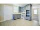Bright kitchen with gray cabinets, modern appliances, and wood-look flooring at 2641 Woodlawn Ave, North Charleston, SC 29405