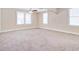 Bright, carpeted living room featuring large windows and neutral-toned walls at 2641 Woodlawn Ave, North Charleston, SC 29405