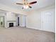 Spacious living room with a ceiling fan, new carpet, and a decorative fireplace at 2641 Woodlawn Ave, North Charleston, SC 29405