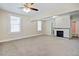 Inviting living room with neutral walls, carpet, a ceiling fan, and a decorative fireplace at 2641 Woodlawn Ave, North Charleston, SC 29405