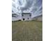 A wide backyard and green lawn space on a cloudy day with neighboring homes at 268 Watersglen Dr, Summerville, SC 29486