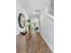 Hallway with light-colored wood floors, side table, decorative mirror and view into the living area at 268 Watersglen Dr, Summerville, SC 29486