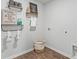 Bright laundry room featuring wire shelving, decor, and wood-look vinyl flooring at 268 Watersglen Dr, Summerville, SC 29486