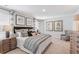 Spacious primary bedroom with a large bed, stylish bedding, and a cozy sitting area at 268 Watersglen Dr, Summerville, SC 29486