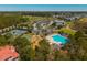 Scenic aerial view of community amenities including a pool, tennis courts, playground, golf course and parking at 2722 Crooked Stick Ln, Mount Pleasant, SC 29466