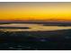 A scenic aerial view of a waterway surrounded by marshland at sunset at 2722 Crooked Stick Ln, Mount Pleasant, SC 29466