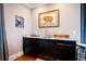 Wet bar with modern sink, granite countertop, black cabinetry, and decorative art at 2722 Crooked Stick Ln, Mount Pleasant, SC 29466