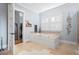 Luxurious bathroom featuring a soaking tub, tiled floors, and natural light at 2722 Crooked Stick Ln, Mount Pleasant, SC 29466