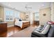 Comfortable bedroom featuring hardwood floors, a ceiling fan, lots of natural light, and a writing desk at 2722 Crooked Stick Ln, Mount Pleasant, SC 29466