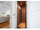 Interior view of a residential elevator with wood paneled walls adjacent to a living area with white trim at 2722 Crooked Stick Ln, Mount Pleasant, SC 29466