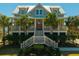 Charming coastal home with a welcoming front porch, beautiful landscaping and palm trees at 2722 Crooked Stick Ln, Mount Pleasant, SC 29466