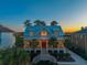 Stunning home with a welcoming front porch, warm interior lights, and professional landscaping at 2722 Crooked Stick Ln, Mount Pleasant, SC 29466