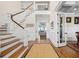 Elegant foyer showcasing hardwood floors, staircase, and view into the living room at 2722 Crooked Stick Ln, Mount Pleasant, SC 29466