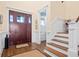 Warm foyer with hardwood floors, a staircase, paneled walls and a striking front door at 2722 Crooked Stick Ln, Mount Pleasant, SC 29466
