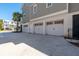 Spacious three-car garage with white doors and a gray exterior, providing ample parking and curb appeal at 2722 Crooked Stick Ln, Mount Pleasant, SC 29466