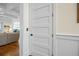Bright hallway with white trim and paneled door leading to a comfortable living space with neutral furniture at 2722 Crooked Stick Ln, Mount Pleasant, SC 29466