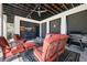 Covered outdoor space featuring a TV, grill, ceiling fan and comfortable seating around a patterned rug at 2722 Crooked Stick Ln, Mount Pleasant, SC 29466