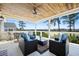 A covered patio with wicker furniture provides a peaceful place to relax outdoors at 2722 Crooked Stick Ln, Mount Pleasant, SC 29466