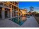 Back exterior featuring a pool, covered patio, and outdoor staircase at dusk at 2722 Crooked Stick Ln, Mount Pleasant, SC 29466