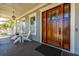Charming front porch with wood door, white columns, and seating, perfect for enjoying the neighborhood at 2722 Crooked Stick Ln, Mount Pleasant, SC 29466