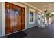 Welcoming front porch with a mahogany front door, white railings and chairs, and a ceiling fan at 2722 Crooked Stick Ln, Mount Pleasant, SC 29466