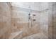 Modern shower featuring a stone pebble floor, travertine walls and built in niche at 2722 Crooked Stick Ln, Mount Pleasant, SC 29466