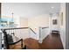 Bright foyer with a staircase featuring white railings, hardwood floors, stylish decor, and lots of natural light at 2722 Crooked Stick Ln, Mount Pleasant, SC 29466