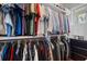 Organized walk-in closet with hanging racks and custom shelving for clothing and accessories at 2722 Crooked Stick Ln, Mount Pleasant, SC 29466
