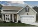 Charming one-story home featuring a 2-car garage, manicured lawn, and beautiful architectural details at 315 Quiet Cove Trl, Summerville, SC 29486