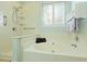 Inviting bathroom features a tub and a shower with an adjustable shower head, shelves, and hand rails at 3438 Farmers Market Dr, Charleston, SC 29414