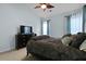 Comfortable bedroom with a large bed, dresser, TV, and soft, natural light from the nearby windows at 3438 Farmers Market Dr, Charleston, SC 29414
