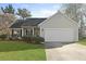 Charming single-story home with a well-manicured lawn and an attached two-car garage at 3438 Farmers Market Dr, Charleston, SC 29414