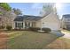 Charming single-story home with a well-manicured lawn and an attached two-car garage at 3438 Farmers Market Dr, Charleston, SC 29414