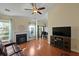 Living room featuring a fireplace, wood floors, and large windows overlooking the backyard at 3438 Farmers Market Dr, Charleston, SC 29414