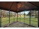 A screened-in patio showcases serene backyard views of the lush lawn and a tranquil lake, providing an inviting outdoor living space at 3438 Farmers Market Dr, Charleston, SC 29414