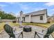 Backyard featuring a fire pit with seating, a well-maintained lawn, and a dining set at 346 Courtney Round, Summerville, SC 29483