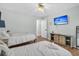 Bright bedroom with two beds, wood floors, ceiling fan, and TV for ultimate comfort and convenience at 346 Courtney Round, Summerville, SC 29483