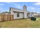 View of backyard with patio dining set and manicured lawn at 346 Courtney Round, Summerville, SC 29483