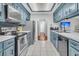 Spacious kitchen features blue cabinets, stainless steel appliances, ample counter space, and tile flooring at 346 Courtney Round, Summerville, SC 29483