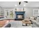 Comfortable living room with a fireplace, hardwood floors, and access to a fenced backyard at 346 Courtney Round, Summerville, SC 29483