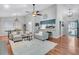 Inviting living room showcasing hardwood floors, comfortable seating, and seamless flow to the dining and kitchen areas at 346 Courtney Round, Summerville, SC 29483