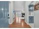 Open-concept living area boasts hardwood floors, stylish blue cabinets, and access to outdoor space at 346 Courtney Round, Summerville, SC 29483