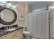 A charming bathroom with a decorative mirror and shower-tub combo at 4006 Hartnett Blvd, Isle of Palms, SC 29451